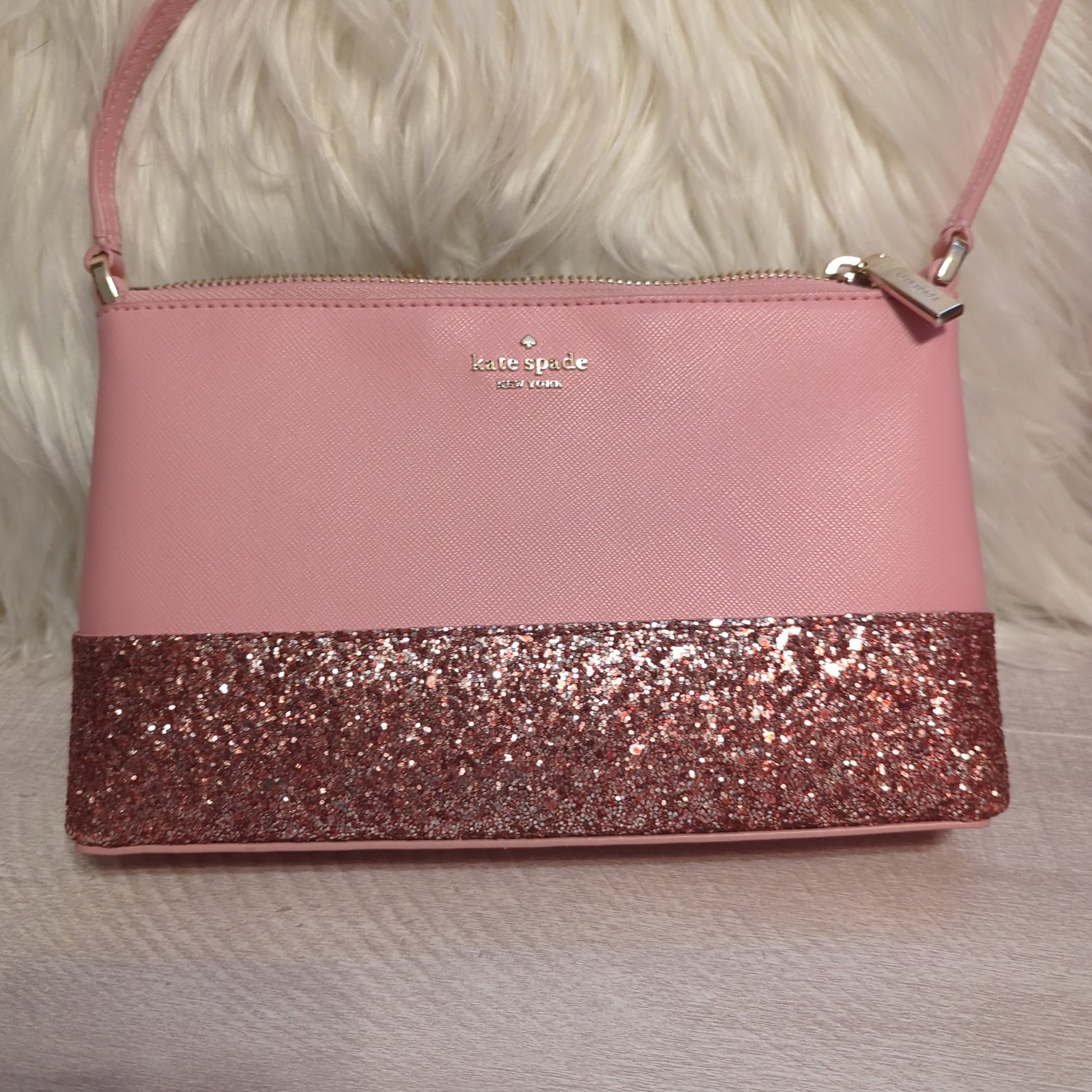 Kate Spade crossbody bag in mauve pink crossgrain leather with pink glitter detailShop this pristine Kate Spade crossbody in mauve with glitter detail. Gold hardware, 9x6 size. Looks unused with immaculate interior/exterior.$179.00Boston304