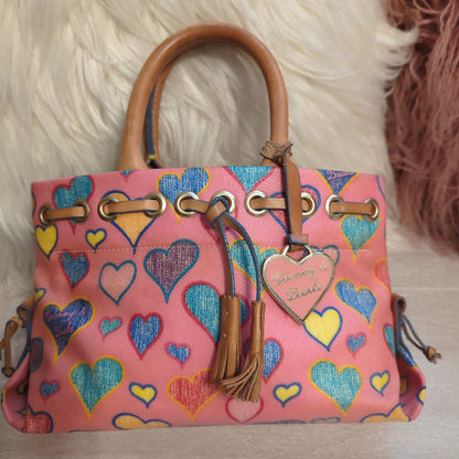 Dooney & Bourke Vintage Tiny Tassel ToteShop the pristine Dooney & Bourke Tiny Tassel Tote with a hearts motif & vachetta leather. Perfect condition with original tag. Ideal size: 10x6x4.$169.00Boston304