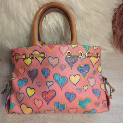 Dooney & Bourke Vintage Tiny Tassel ToteShop the pristine Dooney & Bourke Tiny Tassel Tote with a hearts motif & vachetta leather. Perfect condition with original tag. Ideal size: 10x6x4.$169.00Boston304