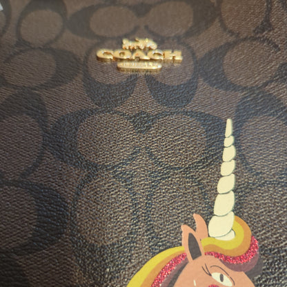 Coach Limited Edition Unicorn Reversible City Tote in Signature Brown/Black MultiExclusive Coach Unicorn Reversible Tote, signature canvas, and wine hue, glitter detailed. A stunning, versatile must-have.$599.00Boston304