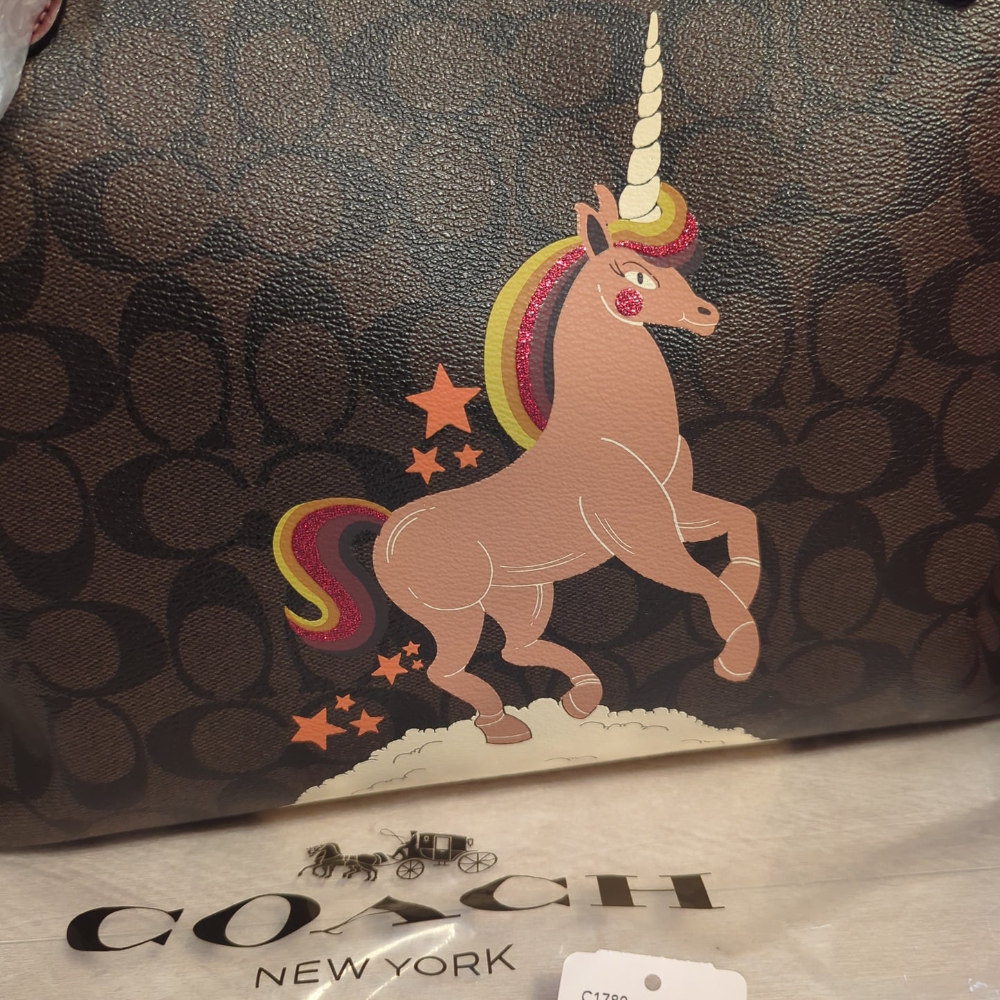 Coach Limited Edition Unicorn Reversible City Tote in Signature Brown/Black MultiExclusive Coach Unicorn Reversible Tote, signature canvas, and wine hue, glitter detailed. A stunning, versatile must-have.$599.00Boston304