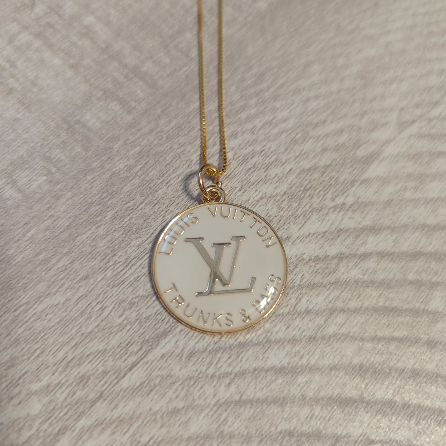 Louis Vuitton white charm on 20 inch 18k gold plated chainBeautiful authentic Louis Vuitton white charm upcycled to a necklace on a 20" 18k plated gold chain. This charm is a perfect 1 inch size.$199.00Boston304