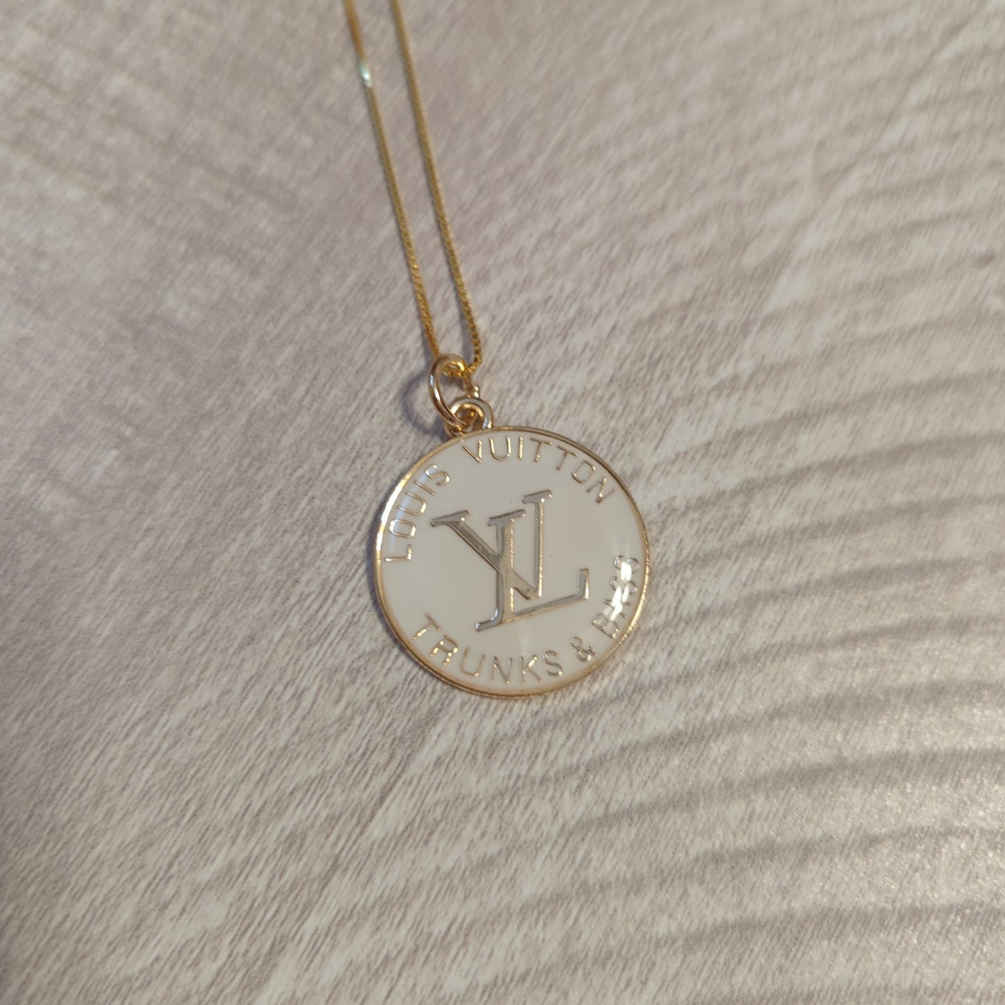 Louis Vuitton white charm on 20 inch 18k gold plated chainBeautiful authentic Louis Vuitton white charm upcycled to a necklace on a 20" 18k plated gold chain. This charm is a perfect 1 inch size.$199.00Boston304