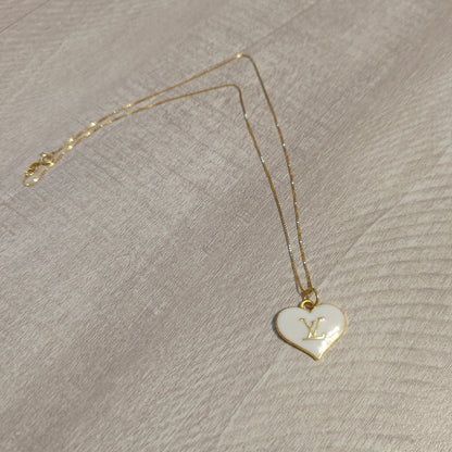 Louis Vuitton white heart charm upcycled to a necklace on an 18 inch box chain in 18k gold plate.Elevate your style with our upcycled Louis Vuitton white heart charm necklace on an 18" gold plated box chain. Perfect elegance.$179.00Boston304