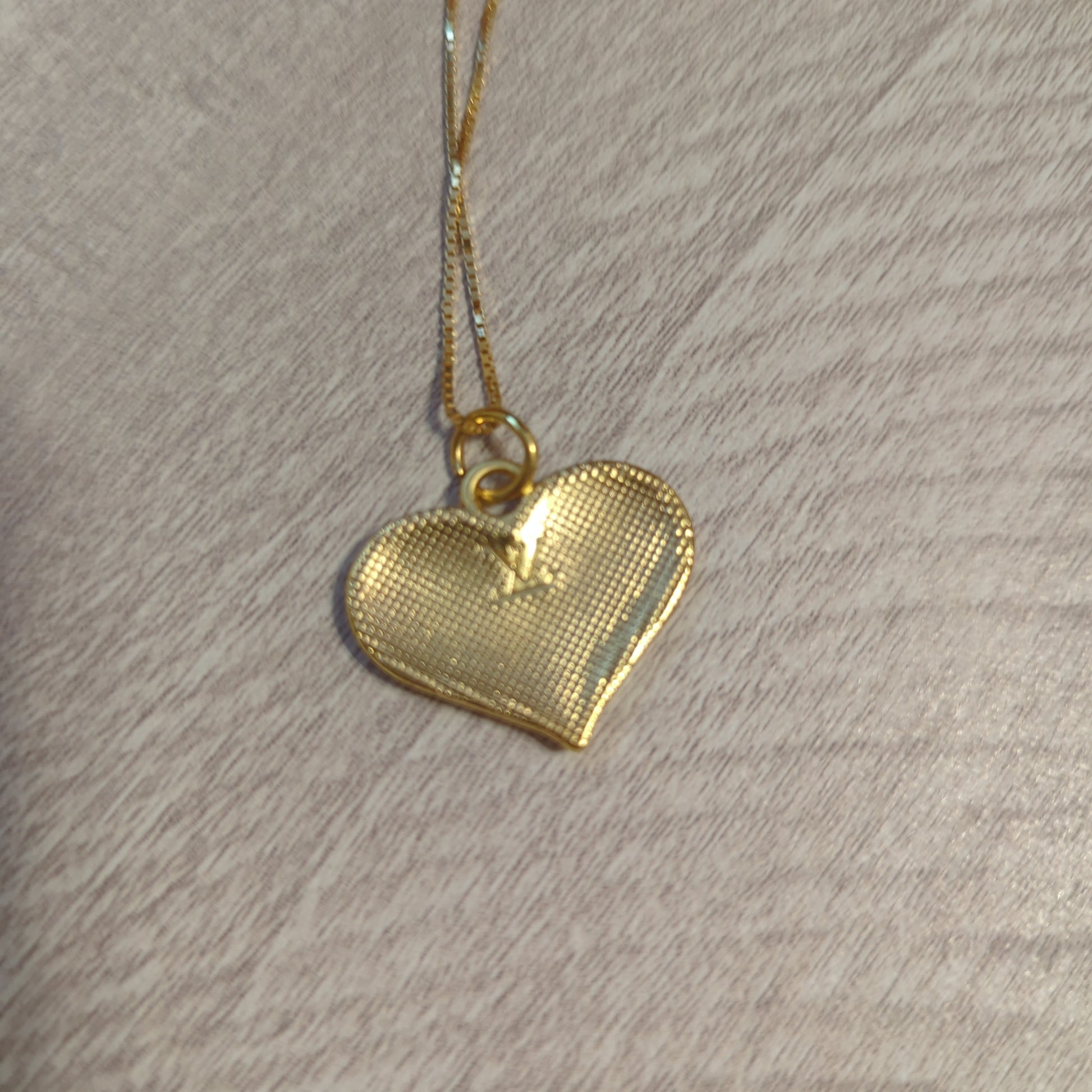 Louis Vuitton white heart charm upcycled to a necklace on an 18 inch box chain in 18k gold plate.Elevate your style with our upcycled Louis Vuitton white heart charm necklace on an 18" gold plated box chain. Perfect elegance.$179.00Boston304