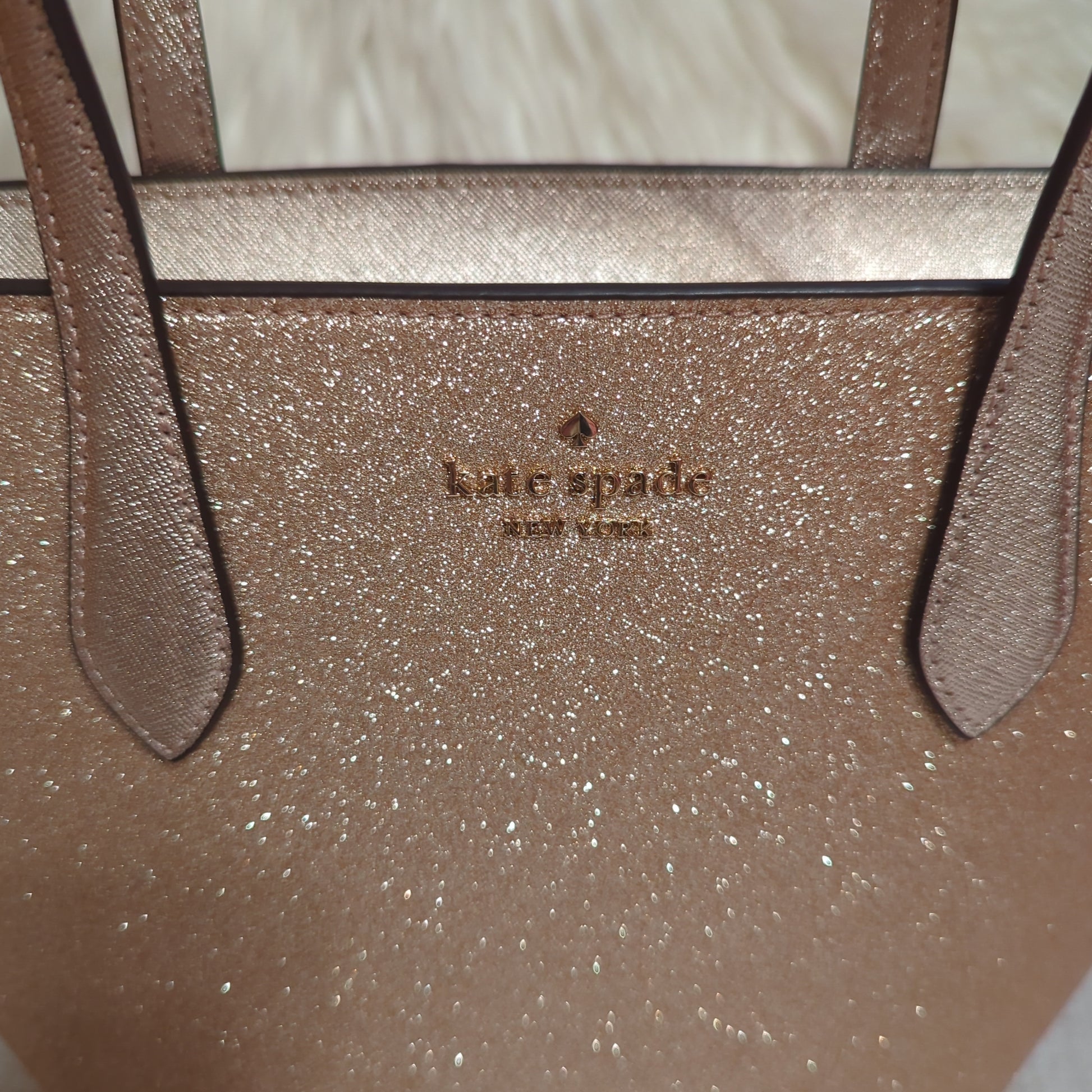 Kate Spade Gold Glimmer SatchelElevate your style with the Kate Spade Gold Glimmer Satchel. Versatile crossbody with elegant shimmer, gold hardware & top zip. Shop now!$199.00Boston304