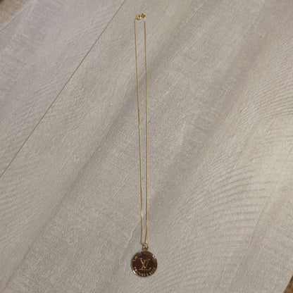 Louis Vuitton brown charm on 20 inch 18k plated necklaceBeautiful Louis Vuitton charm upcycled to a 20 inch 18k plated necklace in a gorgeous chocolate brown and gold. Perfect one inch charm.$199.00Boston304