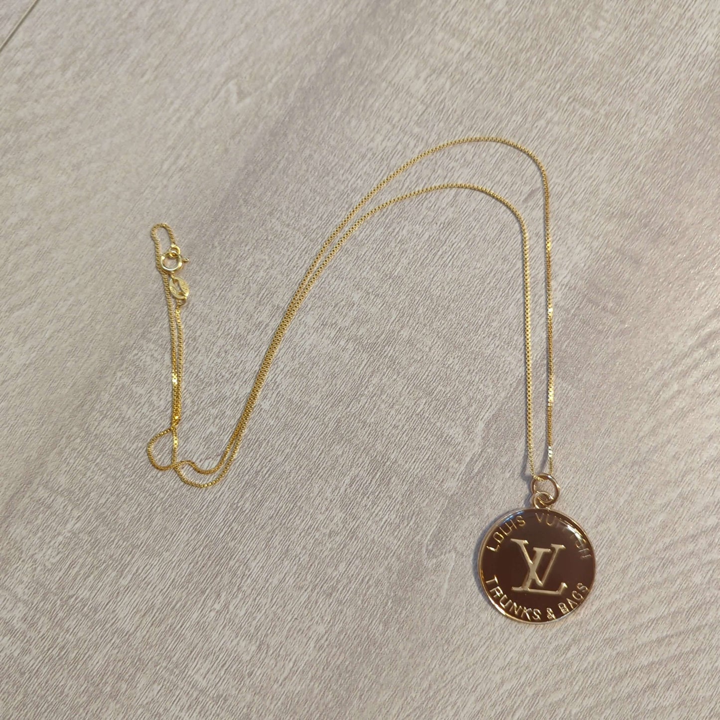 Louis Vuitton brown charm on 20 inch 18k plated necklaceBeautiful Louis Vuitton charm upcycled to a 20 inch 18k plated necklace in a gorgeous chocolate brown and gold. Perfect one inch charm.$199.00Boston304