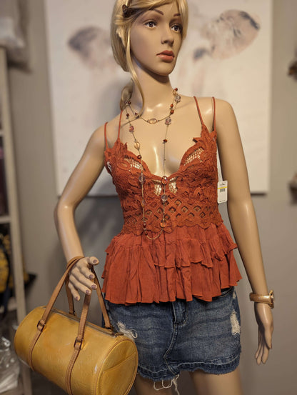 Free People Adella Top in color winding roadsShop the rust-hued Free People Adella Top with adjustable straps for a perfect medium fit. Embrace elegance with the 'Winding Roads' color.$48.00Boston304