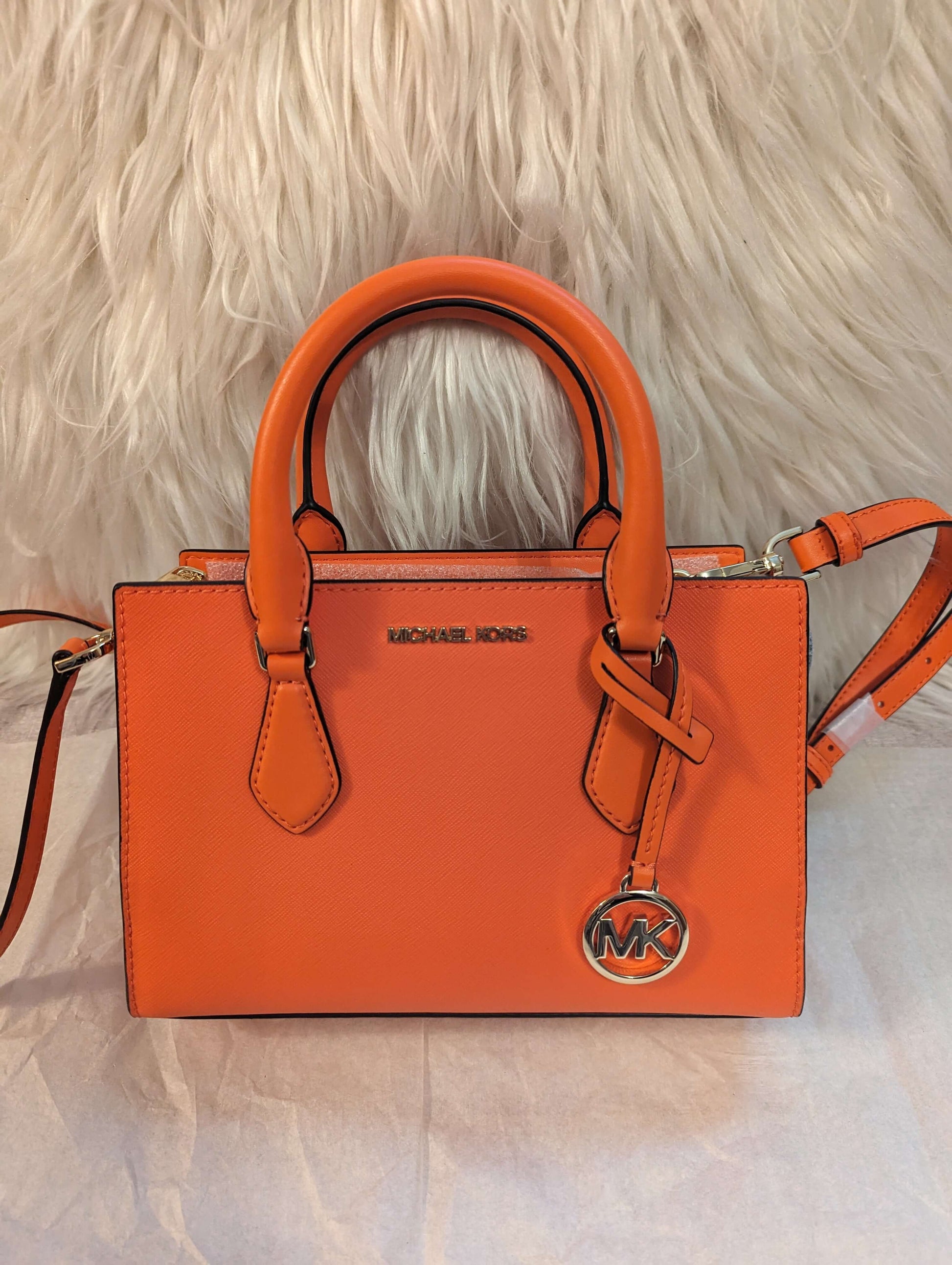 Michael Kors Sheila Center Zip Non Leather Vegan Crossbody Satchel in PoppyGet the chic Poppy Michael Kors Sheila Vegan Satchel. Gold accents, removable strap, and smart compartments. Perfect size at 9x6x3.$369.00Boston304