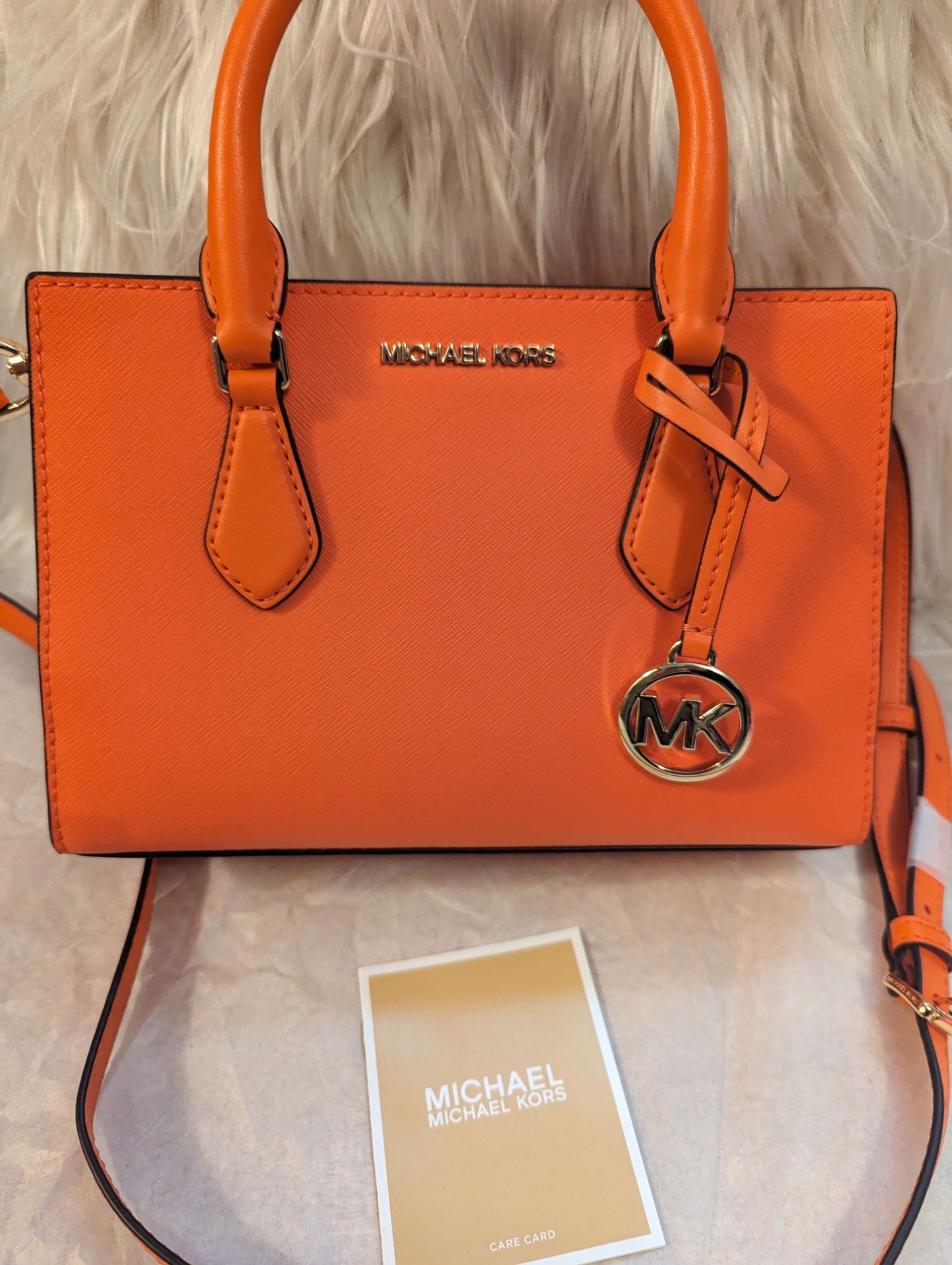 Michael Kors Sheila Center Zip Non Leather Vegan Crossbody Satchel in PoppyGet the chic Poppy Michael Kors Sheila Vegan Satchel. Gold accents, removable strap, and smart compartments. Perfect size at 9x6x3.$369.00Boston304