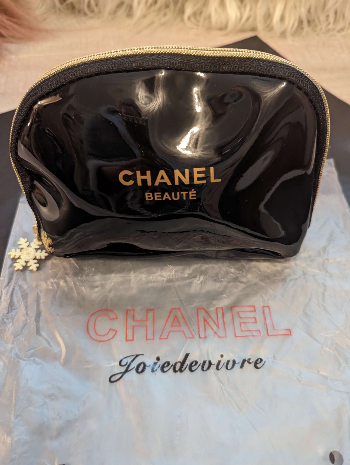 Chanel Beaute patent leather beauty bagElevate your makeup game with the Chanel Beaute black & gold beauty bag, featuring luxe patent leather and a chic snowflake zipper.$139.00Boston304