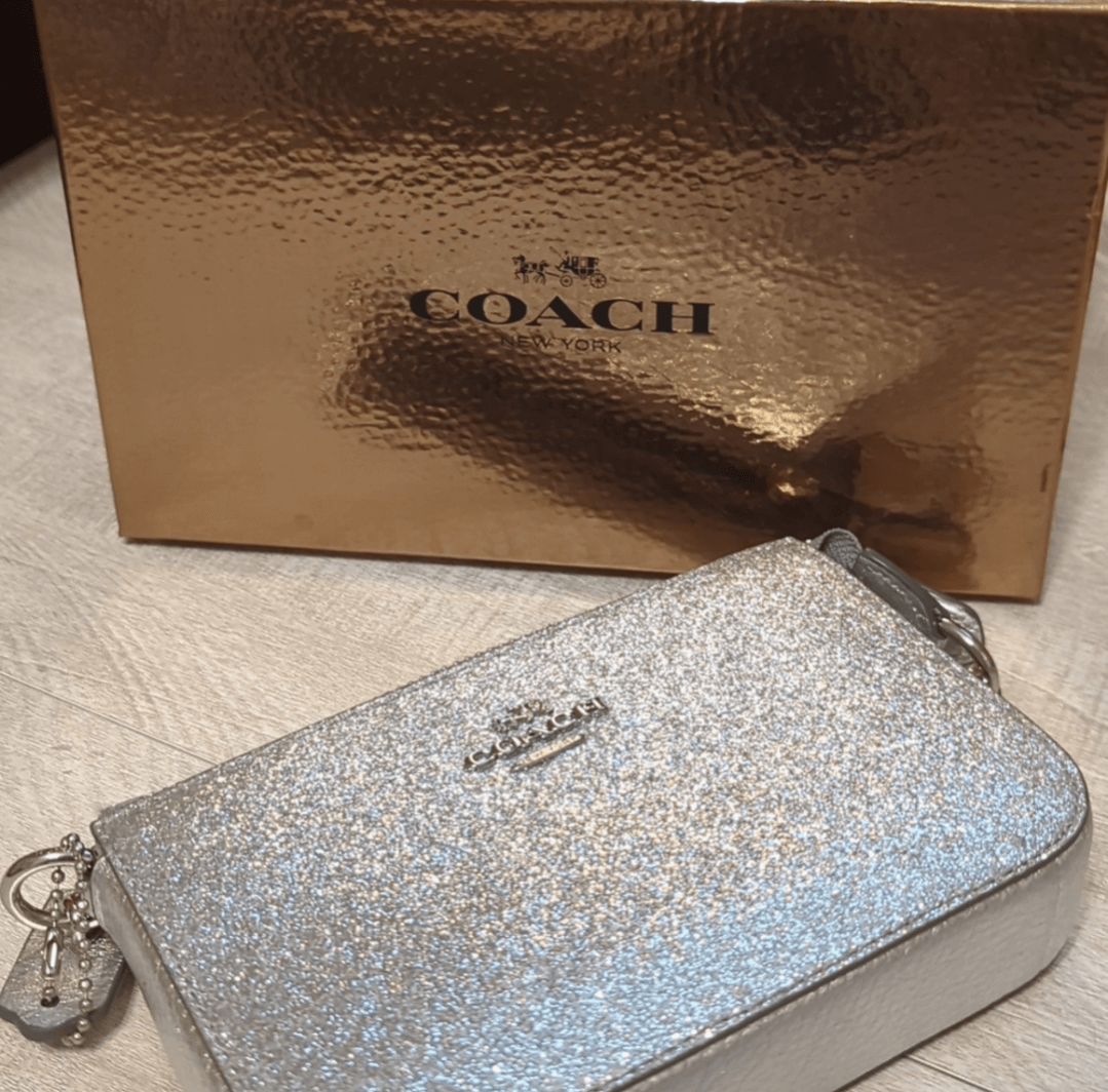 Coach Rare Glitter Chain Wristlet/Clutch BagOwn a vintage Coach wristlet with sparkling silver glitter. Versatile, pristine & boxed - perfect 6x4 luxury accessory. Shop rarity now!$169.00Boston304