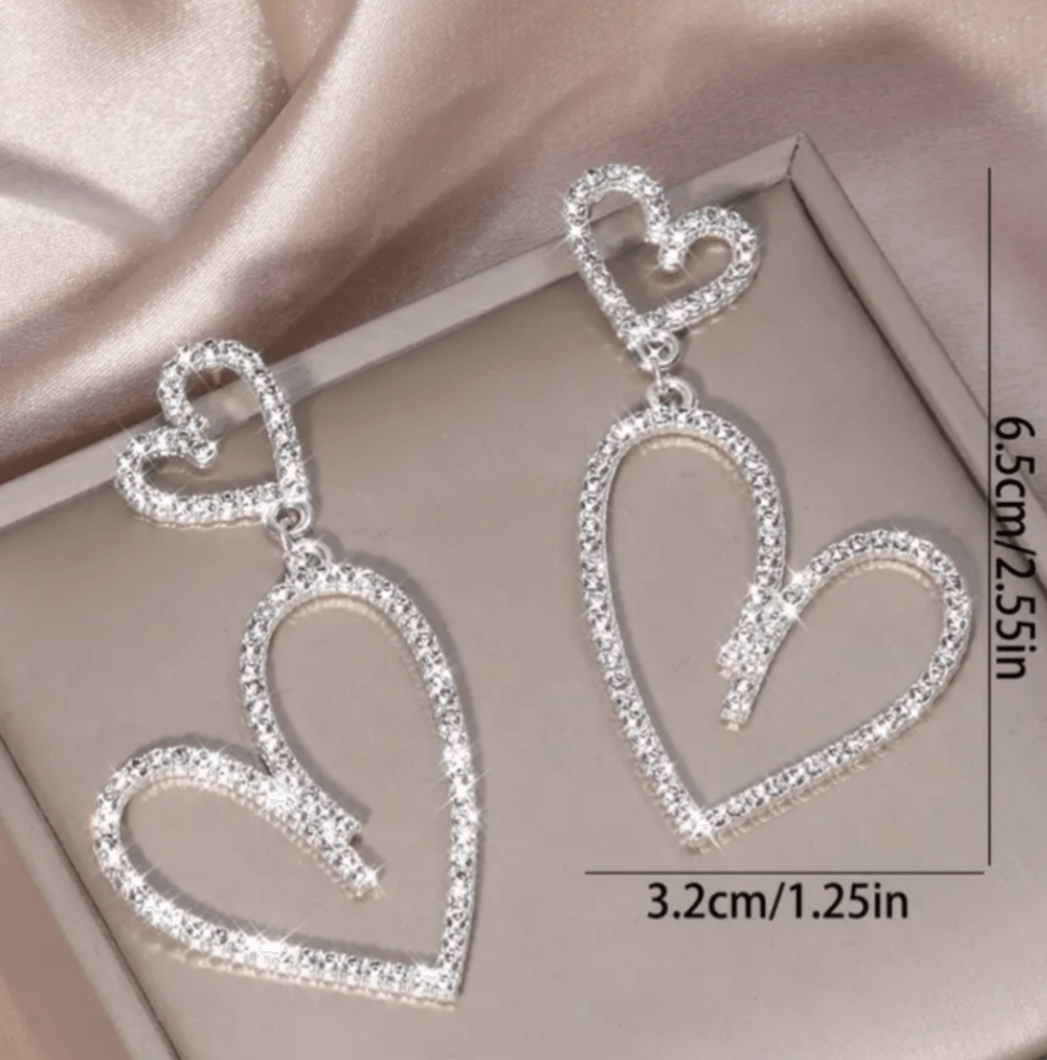 Rhinestone heart dangle earringsElevate your style with these sparkly, lightweight rhinestone heart dangle earrings. Perfect for adding a touch of glam! Shop now.$25.00Boston304